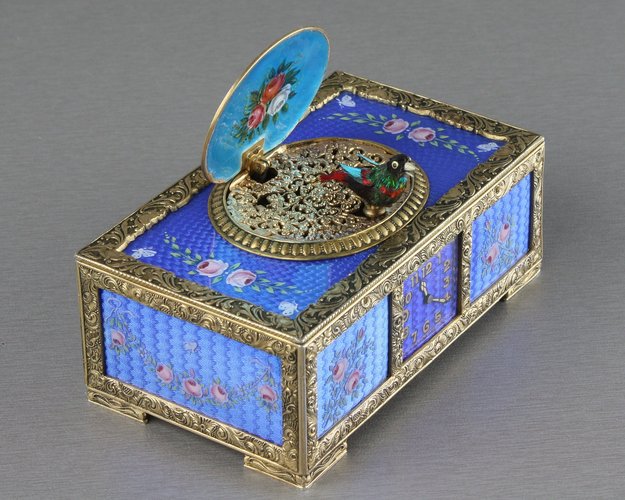 Sterling silver gilt, pictorial and enamel singing bird box with timepiece, movement by C. H. Marguerat